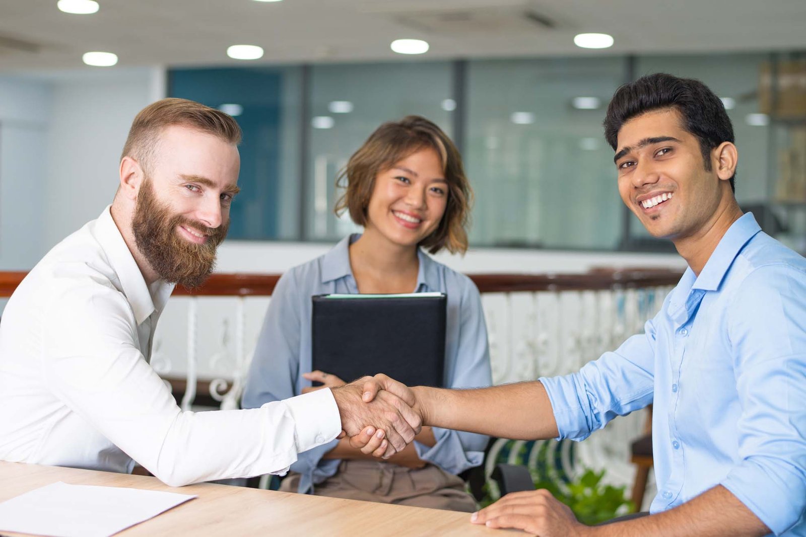 Smiling team leader looking at camera on group corporate meeting
